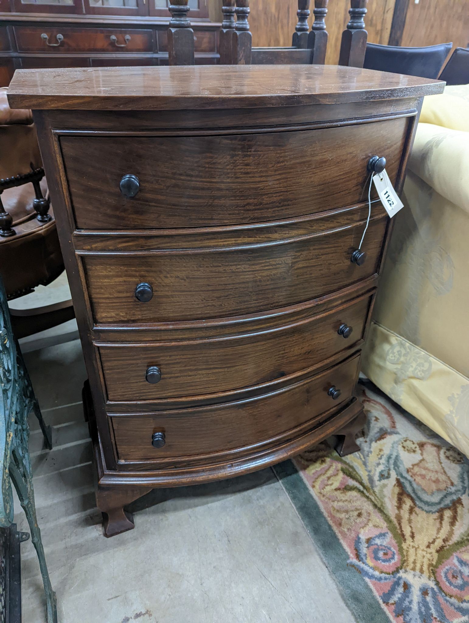 A small reproduction mahogany bow front chest of four long drawers, width 60cm, depth 38cm, height 82cm